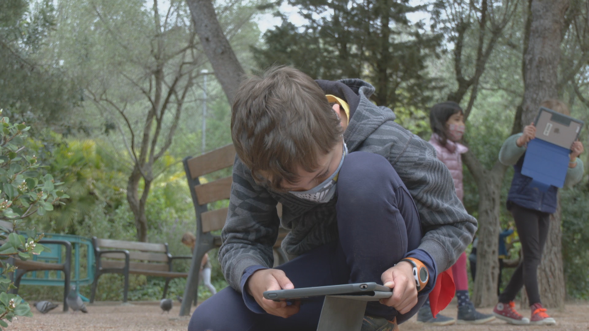 nen grava amb tauleta al Parc Güell